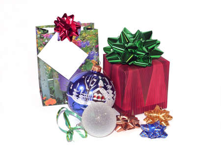 Selection of Christmas presents and ornaments with a white card to put your message onの写真素材