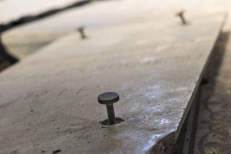 Some nails on a stoneの写真素材