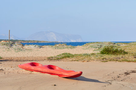A picture of a red kayak on the beachの写真素材