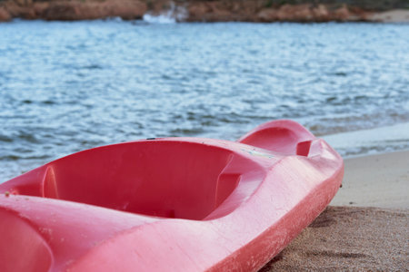 A picture of a red kayak on the beachの写真素材