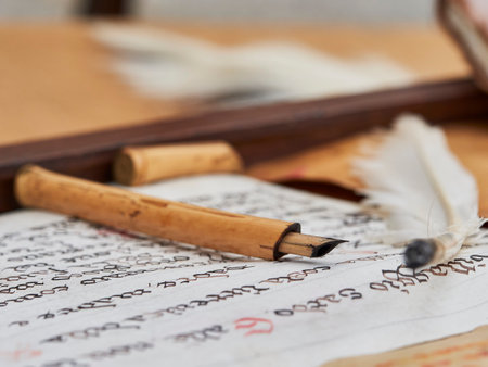 An ancient written scroll of parchment with an ancient penの写真素材