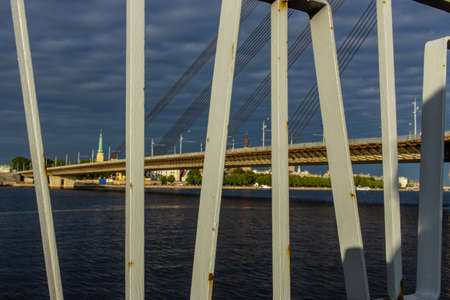 Riga, Latvia- June 29, 2019: capital city bridge view thru the frame in cloudy dayのeditorial素材