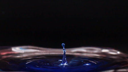 Blue color drop falling in water, creative forms