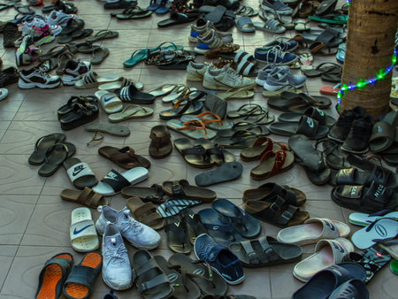 Koh Phangan, Thailand- April 20 2019: tradition take shoes off, view to flip-flops, sundells, shoes