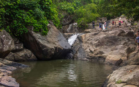 Koh Phangan, Thailand- April 19 2019: natural waterfall visitors touristsのeditorial素材
