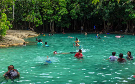 Krabi, Thailand- March 28 2019: crystal blue natural Emerald pool in national water park. Citizens and tourist enjoy sunny day, swimmingのeditorial素材