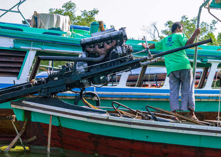 Krabi, Thailand- March 29 2019: Nang An Pier traditional long tail boats made of wood, boat motor and sailor in frontのeditorial素材