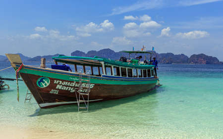 Krabi, Thailand- March 29 2019:traditional wood long tail boat in tirquese blue water, islands tourのeditorial素材