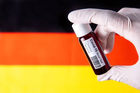 Concept of Coronavirus or Covid-19 pandemic to use as background with German Germany country flag and medical blood testの写真素材