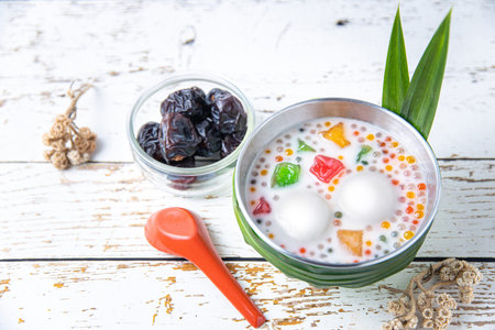 Asian Asia traditional desert bubur chacha or bobo chacha in Malaysia Singapore and Indonesia made of pumpkin, coconut milk, sago and pandan leaf with datesの写真素材