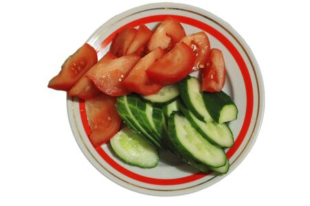  Sliced tomatoes and cocumbers on the round plate isolated on the white backgroundの写真素材