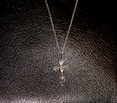 Crucifixion on the dark brown leather backgroundの写真素材