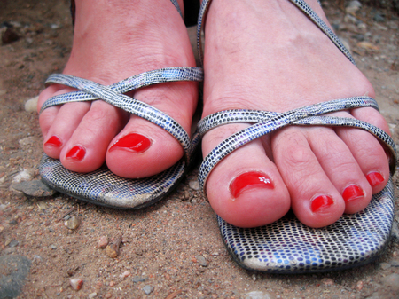 Woman feet standing standing on the groundの写真素材