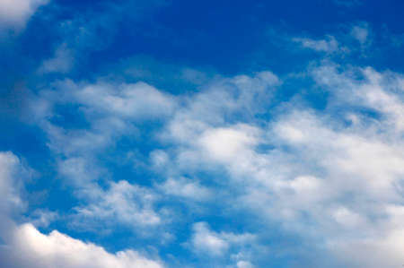 Blue sky and white clouds and the sunの写真素材