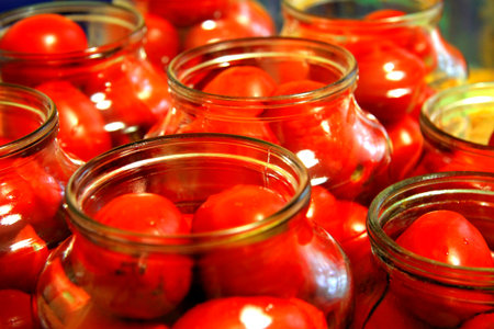Tasty tomatoes ready to canned in glass jarの写真素材