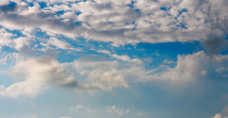 Blue sky and white clouds and the sunの写真素材