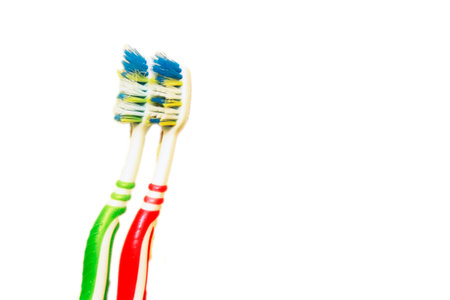 Green and red tooth brushes isolated on the white background