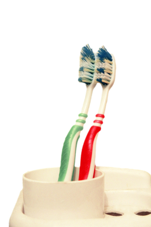 Green and red tooth brushes isolated on the white backgroundの写真素材