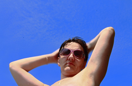 Woman in sun glasses on the shore summertimeの写真素材