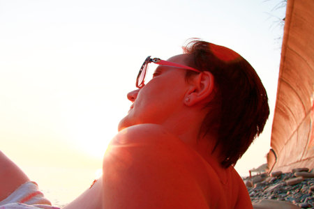 Woman in sun glasses on the shore summertime