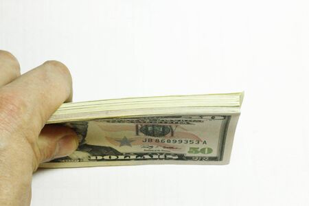 Mans Hand Holding A Stacks Of Paper Dollars Usa On The White Backgroundの写真素材
