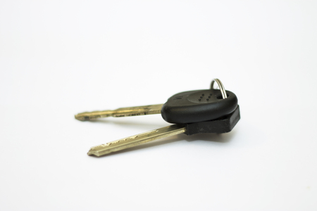 Black car key and block key isolated on white backgroundの写真素材