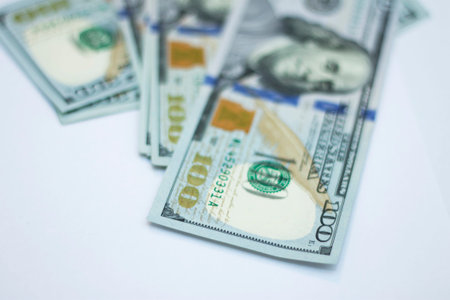 Blured stack of fresh paper 100 dollars USA isolated on the white background