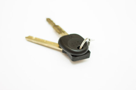 A starting car key and block key isolated on white background