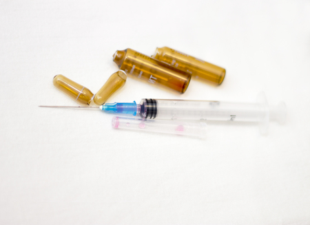 Empty medical ampoules infusion and used syringe after injection isolated on white backgroundの写真素材