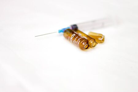 Empty medical ampoules infusion and used syringe after injection isolated on white backgroundの写真素材
