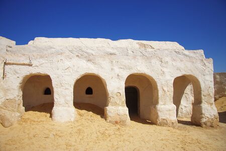 Building decorations of movie Star Wars Episode First in Sahara desert against clear blue sky, Nefta, Tunisia 14 october 2018の写真素材