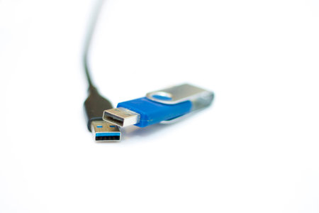 The USB cable and usb flash memory isolated on the white background