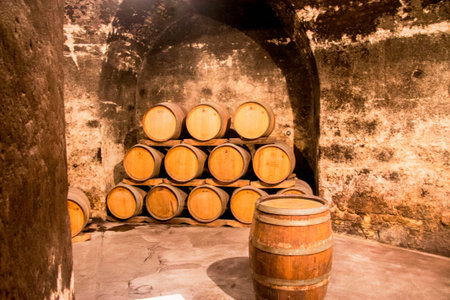 An Old wooden grunge barrels store in the wine cellar of monastery