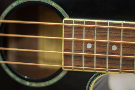 An acoustic bass guitar exremally closeup isolated on the white background