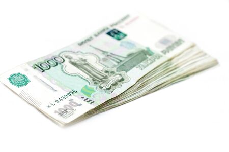Scattered Russian 1000 rubles banknotes closeup isolated on the white backgroundの写真素材