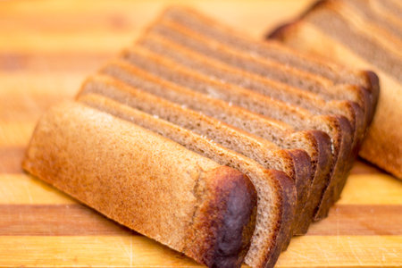 Black rye bread sliced on a wooden cutting board