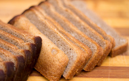 Black rye bread sliced on a wooden cutting board