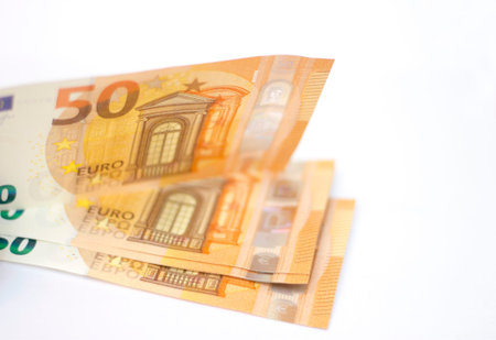 Stack of Fifty euro banknotes laying isolated on white background