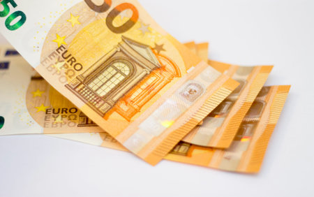 Stack of Fifty euro banknotes laying isolated on white background