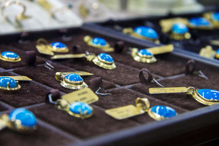 Jewelry hanging with blue stone on the shelf of jewerely store Turkey 27 september 2019のeditorial素材