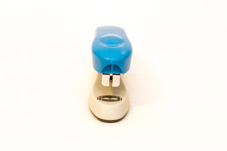 Blue and gray stapler office supplies close up isolated on the white background fromt view