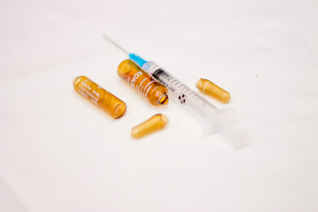 An Empty medical ampoules infusion and used syringe after injection isolated on white background