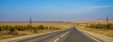 The road and moving cars at daytime and blue sky overの写真素材