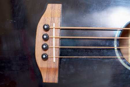 An acoustic bass guitar closeup isolated on the white background