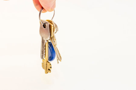 Man hold a Bunch of different flat keys isolated on the white background