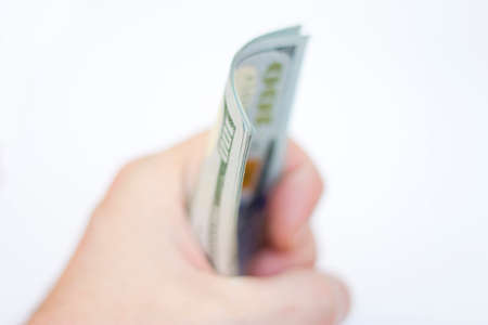 Man ready to exchange pack of new 100 Paper Dollars Usa isolated On The White Backgroundの写真素材