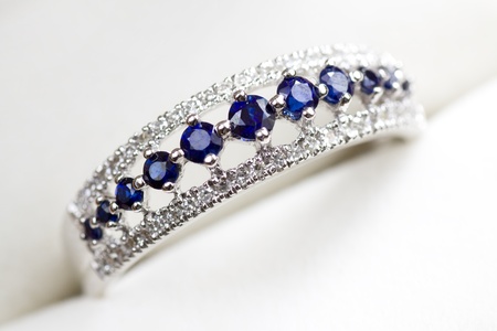 A white gold engagement ring with diamond and sapphire in a box.の写真素材