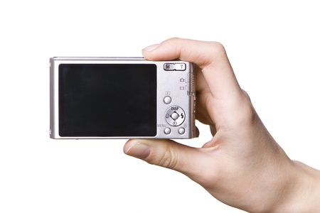 The digital camera in a hand, isolated on whiteの写真素材