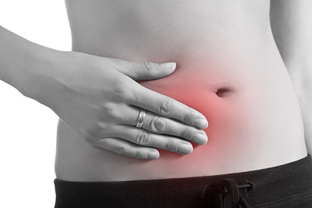 Woman holding stomach in painの写真素材