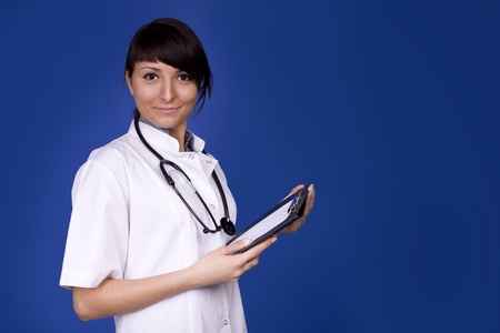 Young Healthcare Worker. Female doctor smiling on blue background.の写真素材